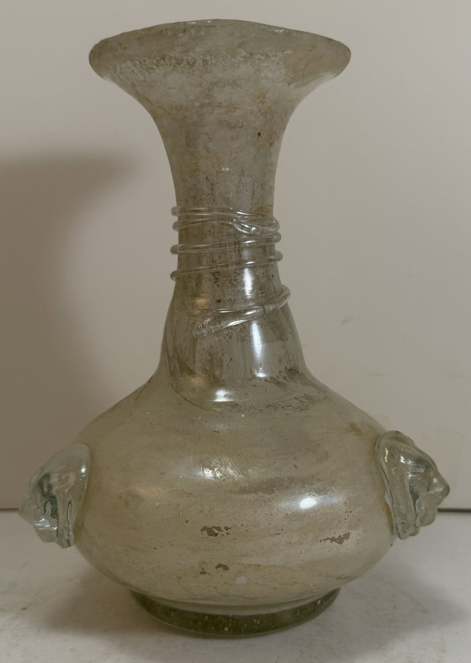 Murano Scavo Glass Vase, early 20th Century: The vase with applied decorative lion heads to the body and a thread detail to the neck. Scavo is a glass technique or patina developed in Murano that celebrates antiquity. It aims to imitate the