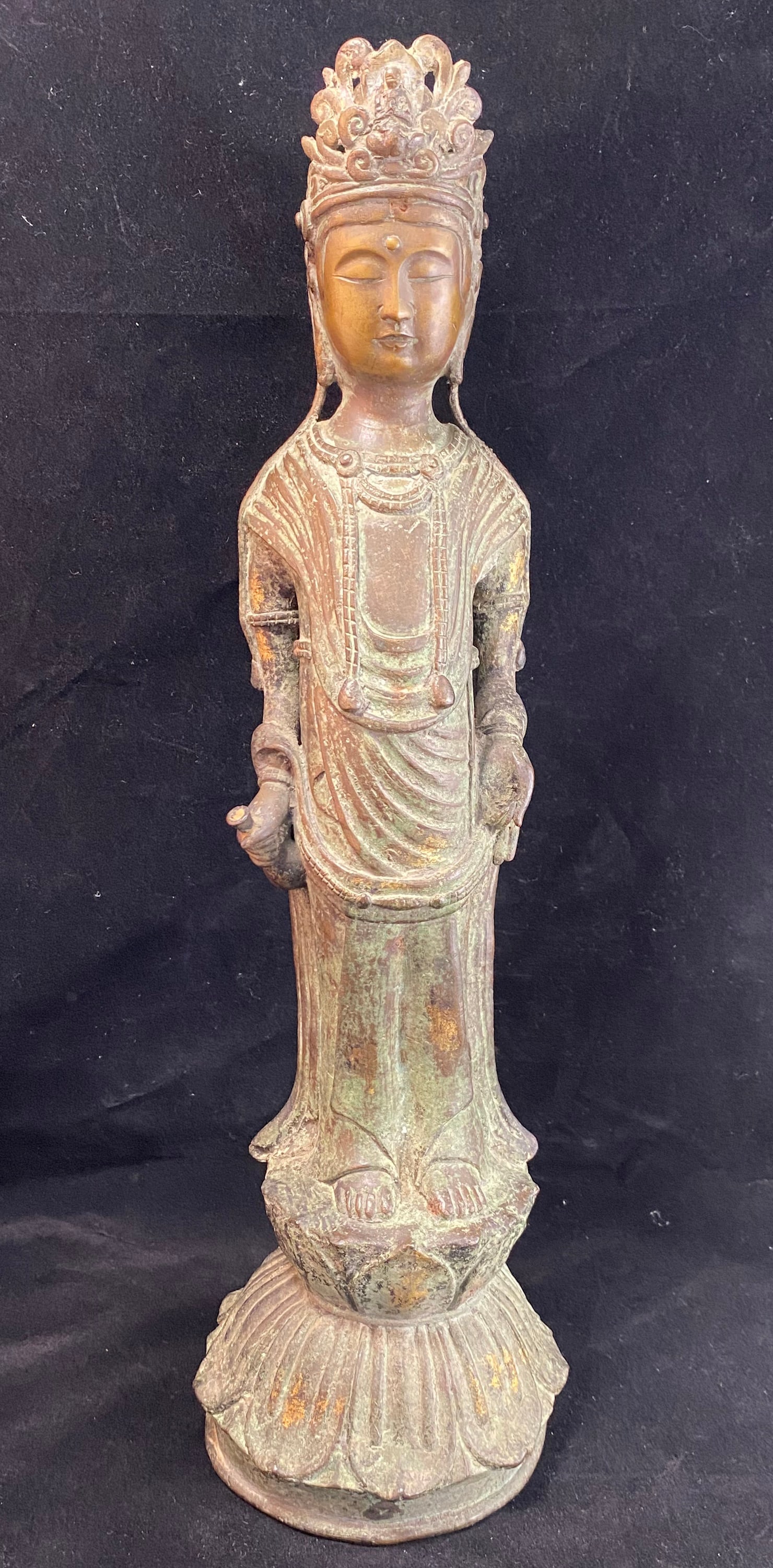 Korean Bronze Standing Buddha: Bronze standing figure of buddha on a lotus stand, the figure with a thin elongated body and serene face. Height: 17 1/2 inches (The base 5 by 5 inches). Weight: 8 lbs. 11 oz.