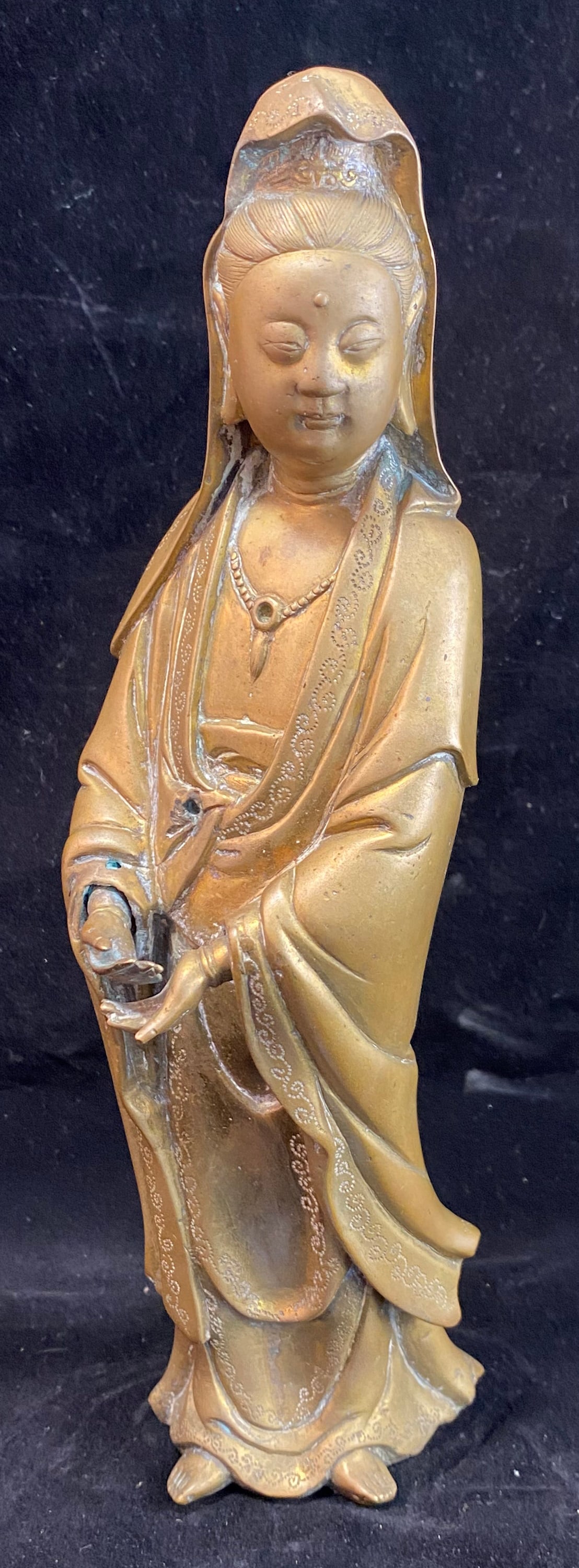 Chinese Bronze Standing Figure of Guanyin: Guanyin is the goddess of compassion and mercy and has a large following in China and other parts of Asia. Height: 9 7/8 inches, Width: 3 inches, Depth: 2 3/4 inches. Weight: 3 lbs. 6 oz. This item is