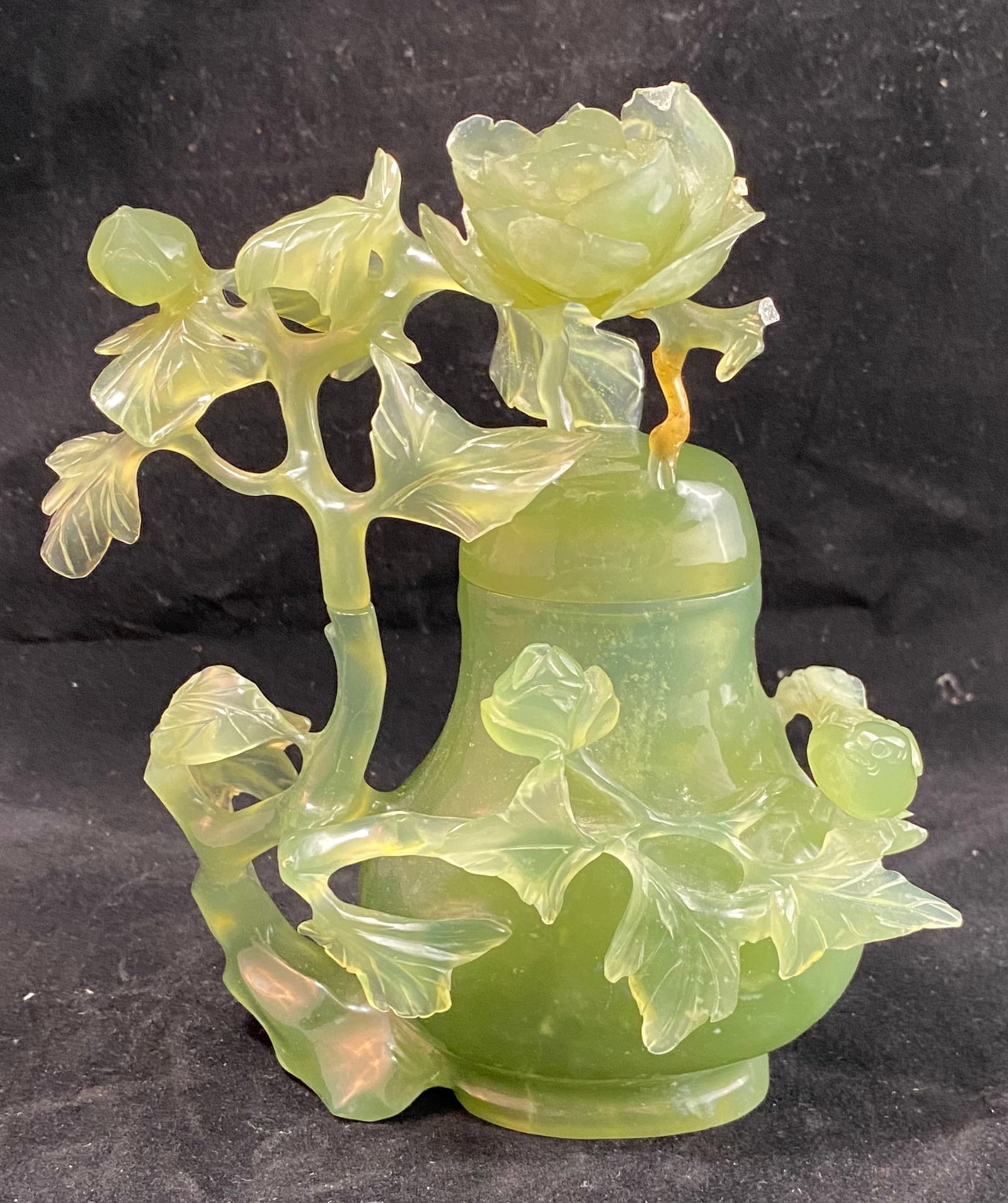 Chinese Hardstone Vase and Cover: Carved with a bird and peony, (the cover with a small break to the carving). Height: 6 1/4 inches, Width: 5 1/4 inches, Depth: 2 1/2 inches. Weight: 1 lb. 3 oz. This item is at our New York location.