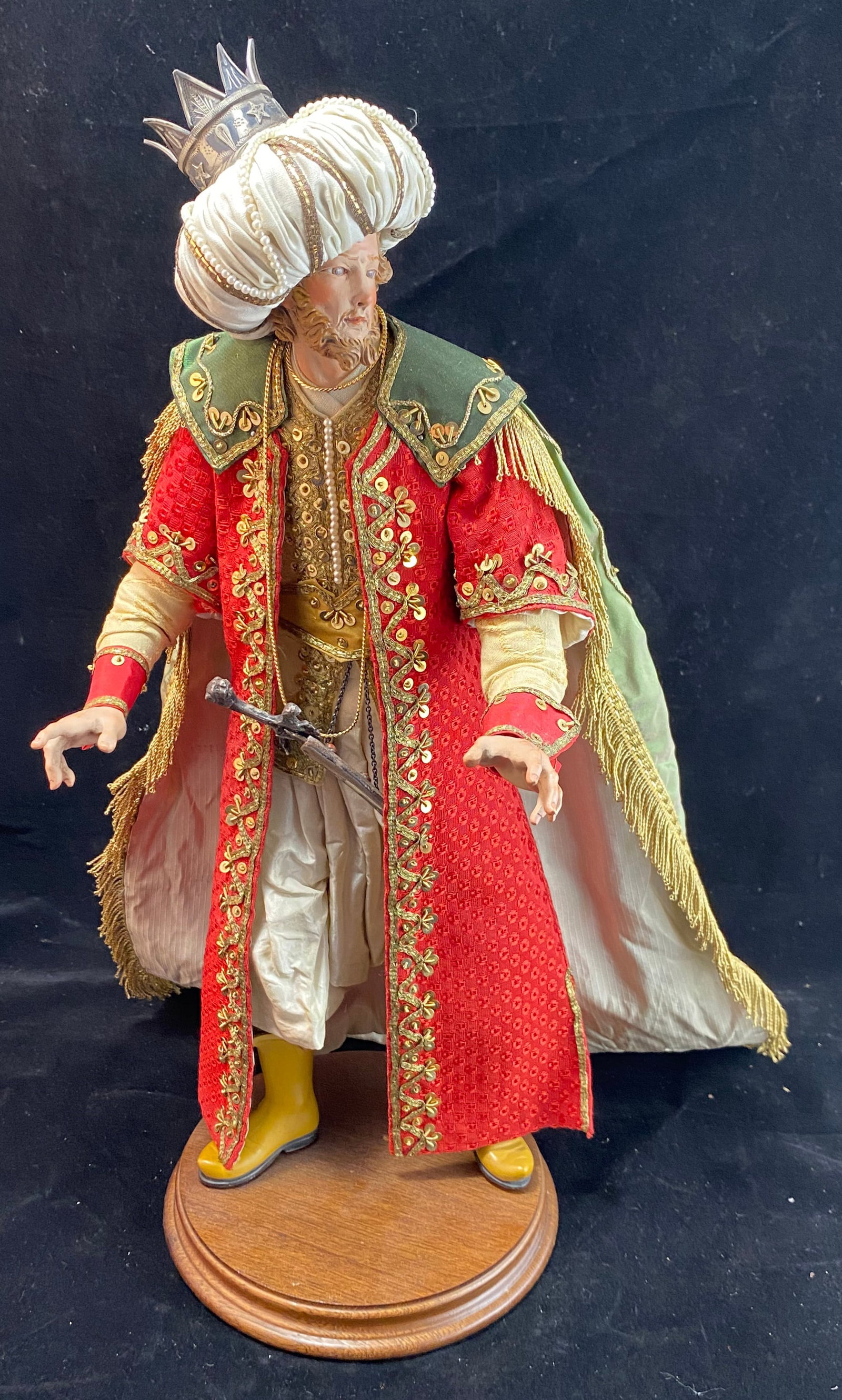 Neapolitan Creche Figure of a Magi, 18th Century: With intricately detailed clothing, including a silver sword, hallmarks ‘800’, that comes out of the sheath, the details include seed pearls, gilt threads, silk textiles, and sequins, the face
