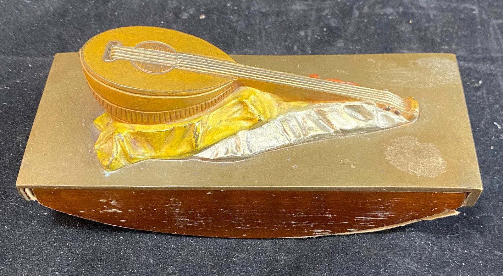 Austrian Cold Painted Bronze Blotter with a Lute: Marked Made in Austria, cast with a colacione or giraffe lute. 5 3/8 by 2 1/4 inches, Height: 2 3/8 inches. Weight: 12 oz.