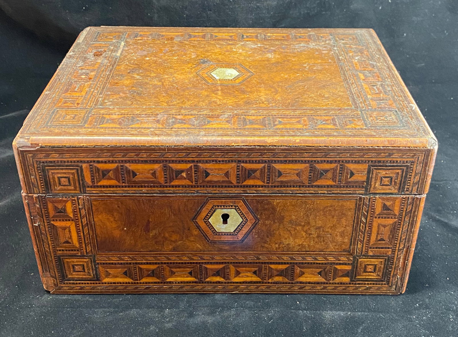 Marquetry Inlaid Wood Box, 19th Century: Inlaid shell detail and lock surround, the box with geometric design. Height: 5 7/8 inches, the top 11 3/4 by 9 inches. Weight: 3 lbs. 7 oz.