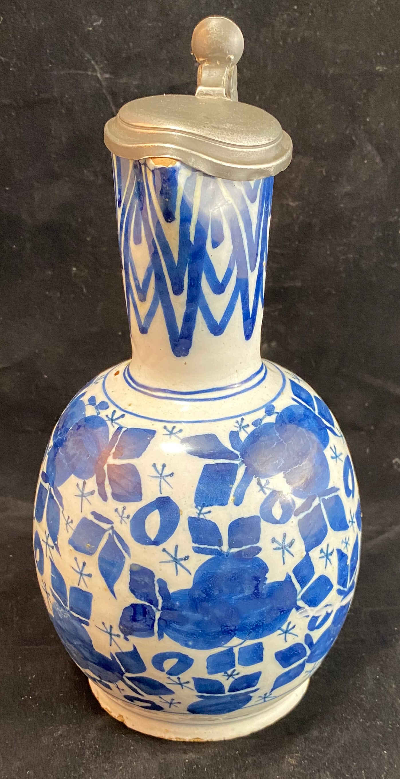Dutch Delft Blue Jug or Pitcher with Pewter Lid, 18th Century: Restoration on the handle. Height: 9 3/4 inches, Width: 6 1/4 inches with the handle, Depth: 5 inches. Weight: 2 lbs. 1 oz.