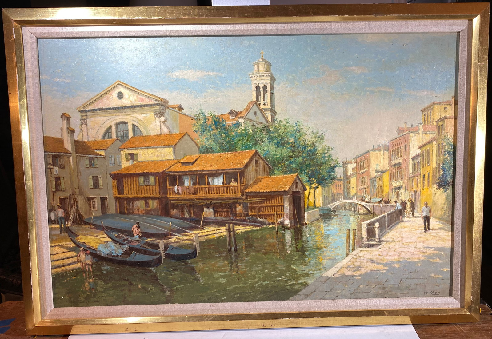 Eric Bruce McKay (1907-1989), Venetian Canal Scene, Oil on Canvas, mid to late -20th Century: Signed McKay in the lower corner. Image size 23 by 25 1/4 inches, overall 27 1/2 by 39 1/2 inches, Depth: 1 3/4 inches. Weight: 9 lbs. This item is at our New York location.