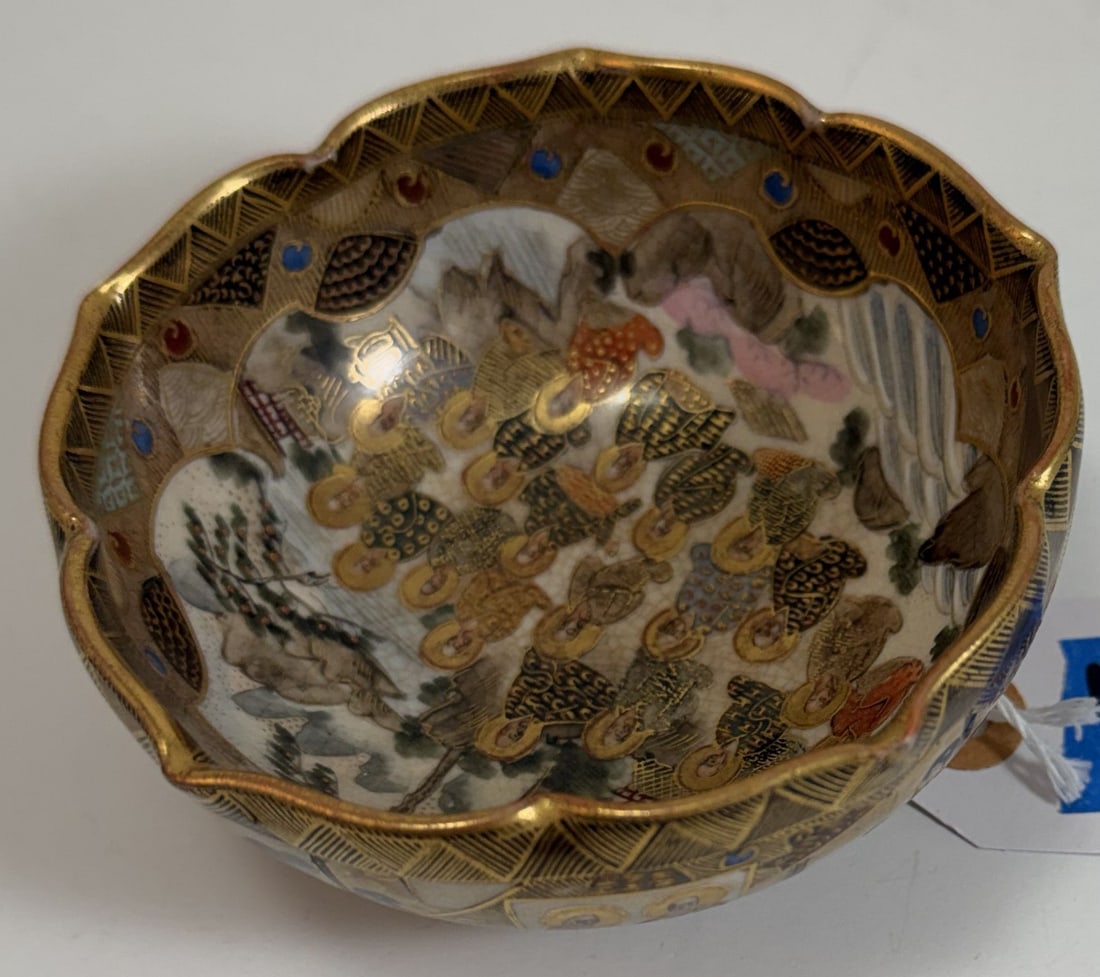 Japanese Satsuma Bowl with Foliate Rim, Signed, early 20th Century: With a Shimazu mark on the underside, decorated with immortals in a landscape. Diameter: 4 1/4 inches, Height: 1 7/8 inches. Weight: 6.5 oz.