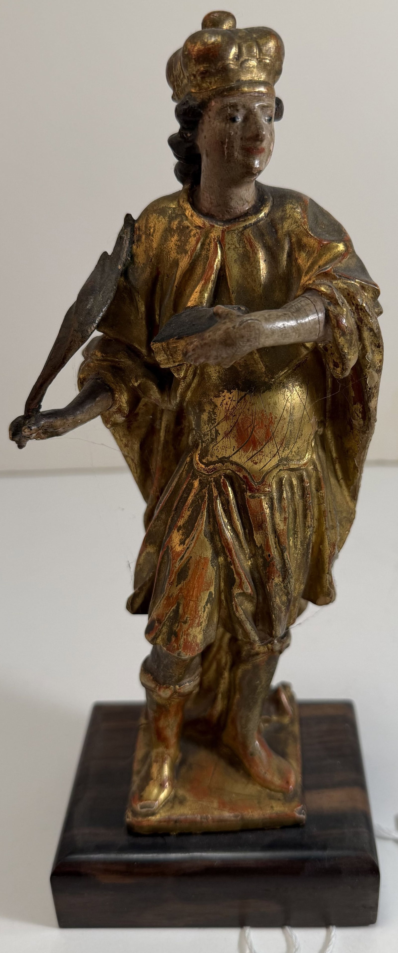 Spanish Colonial Gilt and Polychrome Figure of a Saint, 18th Century: Some scattered chips, and with a crack or possible repair to one of the arms. Height: the figure 8 x 3 1/2 x 2 1/4 inches, overall 9 inches high with the stand. The base 3 5/8 by 2 1/2 by 1 inch.