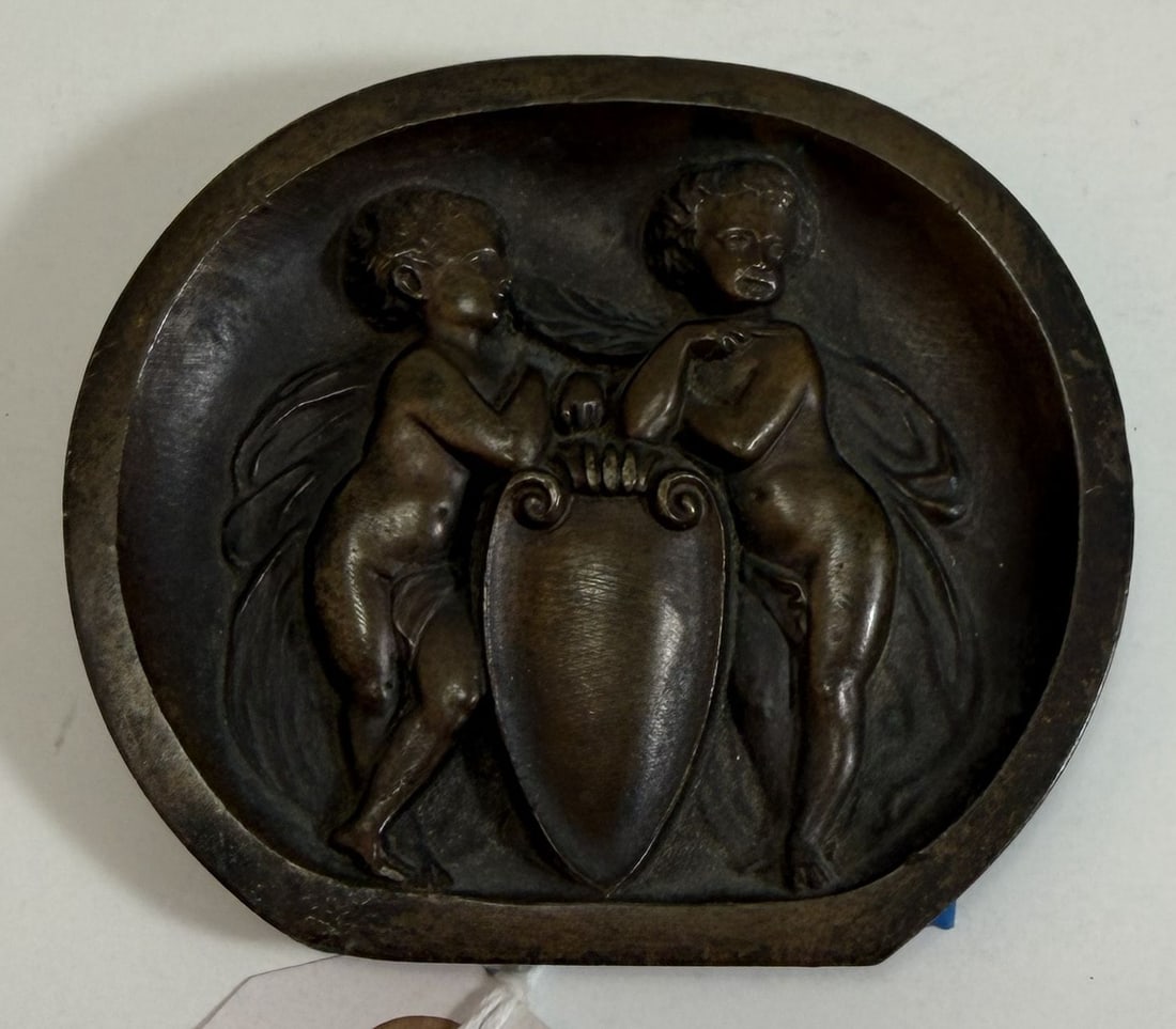 European Cast Bronze Renaissance Style Roundel: Cast with two Eros and Psyche and a shield or crest. 2 7/8 x 3 3/8 x 3/8 inches. Weight: 6.3 oz. This item is at our New York location.