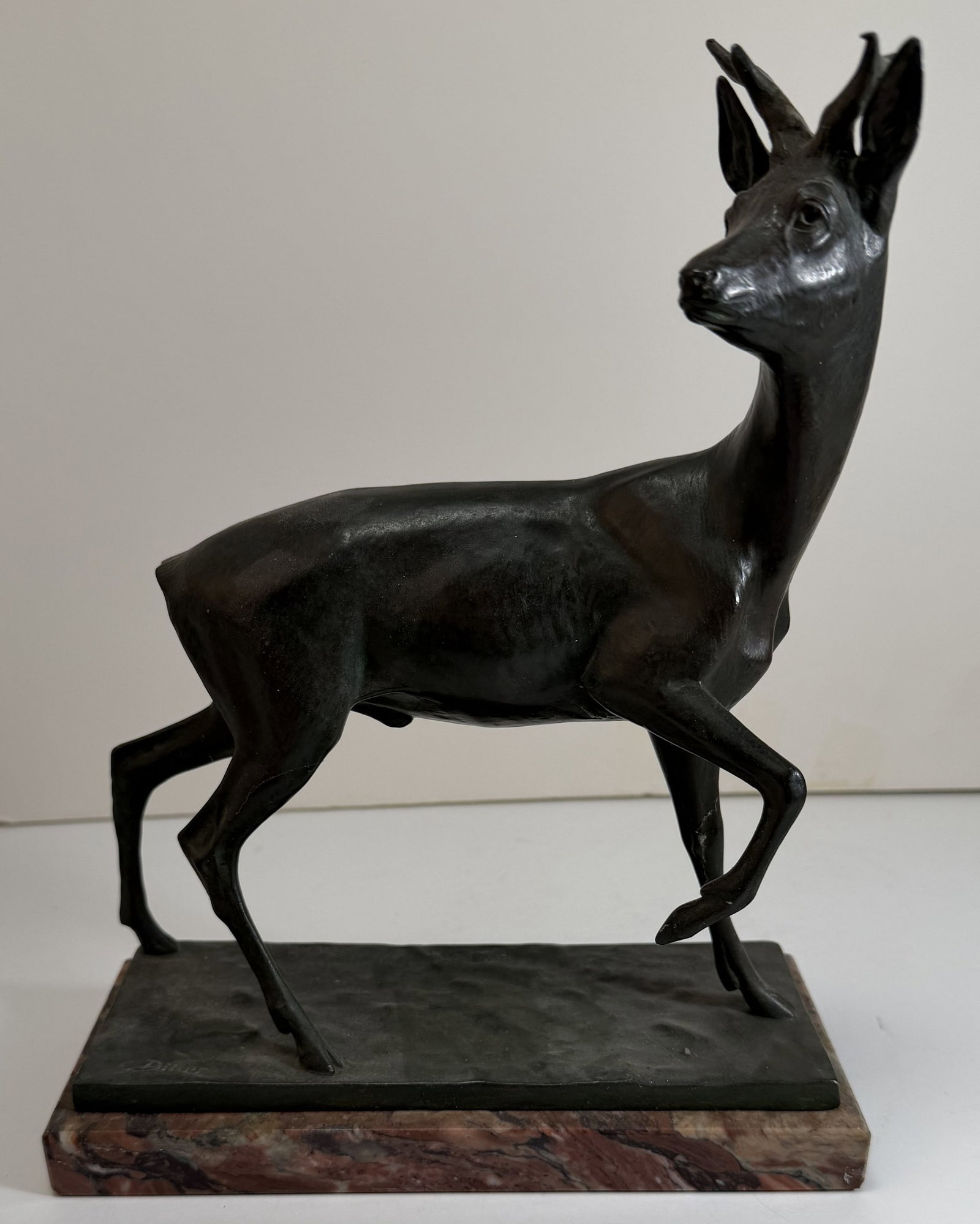 Fritz Diller (1875-1946), Bronze Figure of a Deer: Signed Diller on the base, with a red marble base, with a break to one antler. Height: 10 1/4 x 7 15/16 x 3 1/4 inches. Weight: 4 lbs. 12 oz.