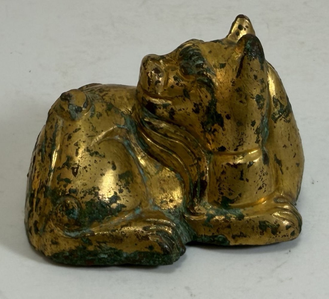 Chinese Gilt Bronze Figure of a Tiger: Possibly was originally a scroll weight. Width: 2 5/8 inches at the widest point, Height: 1 1/2 inches, Depth: 2 inches. Weight: 10.2 oz.