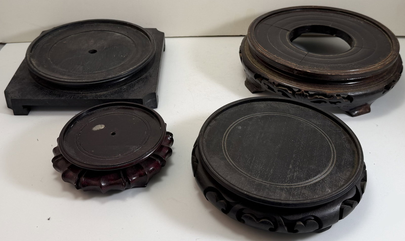 Four Chinese Carved Wood Stands: Diameter: the largest 8 inches overall. Would fit vases 3 3/4 inches, 6 inches, 7 inches and 6 3/8 inches. Weight: 3 lbs. 9 oz. Total