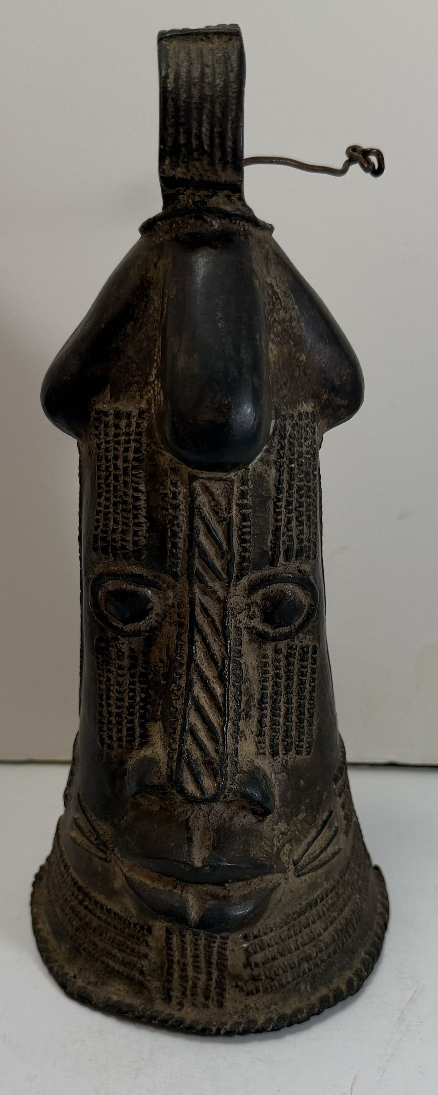 Rare African Nupe Bronze Face Form Rattle, Niger.: Height: 9 inches, The base 4 1/4 inches in diameter. Weight: 2 lbs. 5 oz. This item is at our New York location.