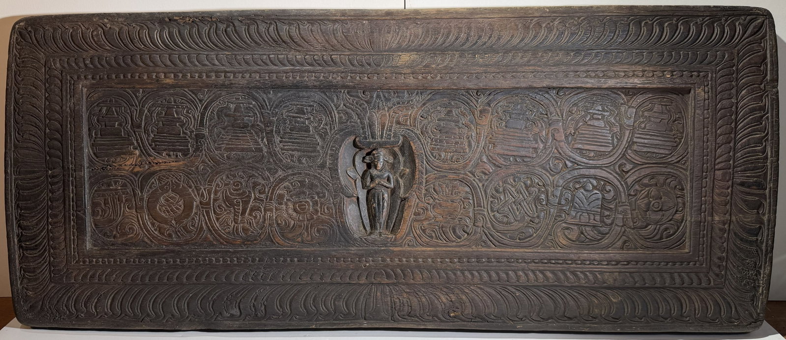 Tibetan or Nepalese Buddhist Carved Hardwood Sutra Cover, 17th/18th Century: Carved with Eight Stupas and the eight buddhist auspicious symbols. 12 1/4 x 28 3/4 x 1 1/2 inches. Weight: 11 lbs. 4 oz. This item is at our New York location.