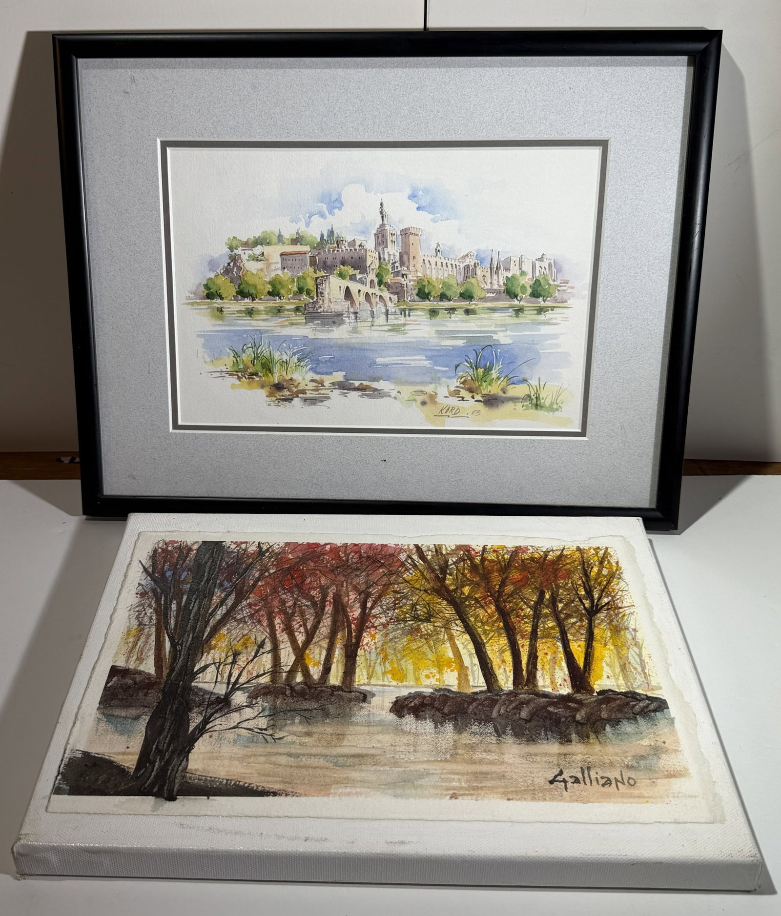 Two Works on Paper, Watercolor and Gouache, Landscapes: The first a European scene with a castle and aqueduct bridge, signed ‘Kord’ and dated ’03’; the second paper affixed to canvas, signed ‘Galliano’. Kord: image size 6 by 9 inches, overall