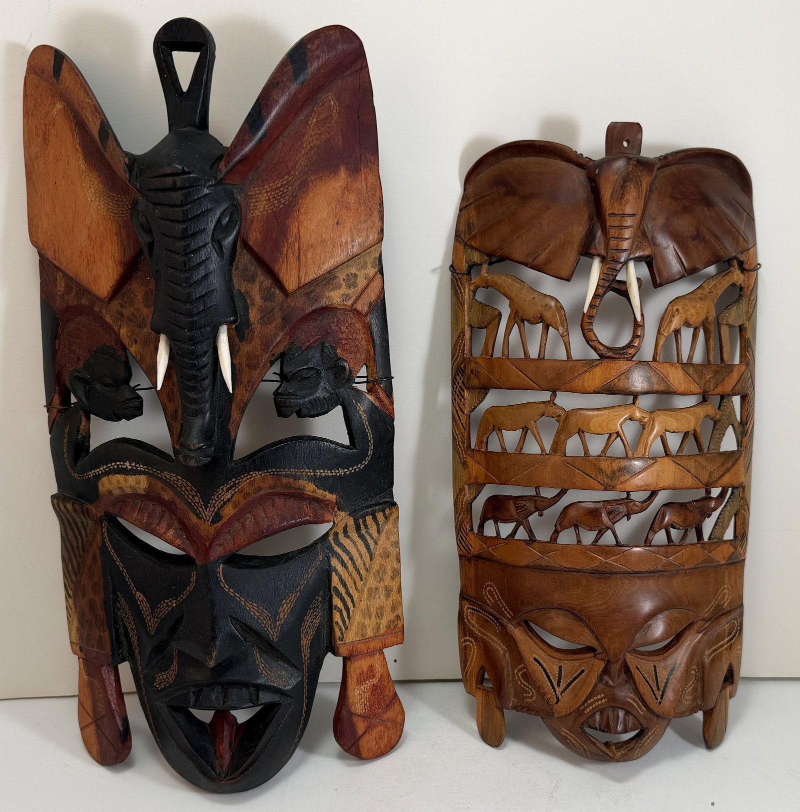 Two African Carved Wood Wall Hangings: 13 1/2 x 6 1/2 x 2 1/2 inches and 11 3/4 x 5 3/4 x 2 1/4 inches. Weight: 1 lb. 9 oz. total