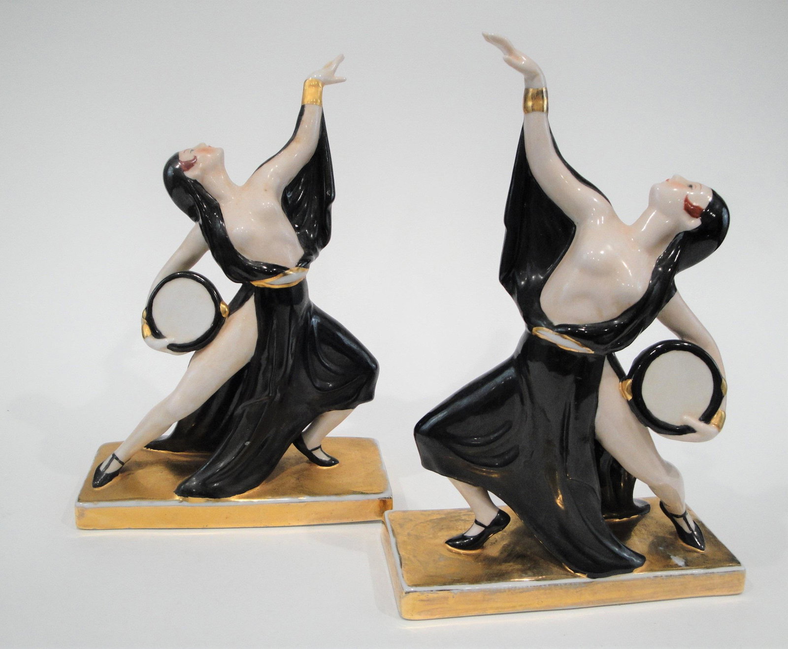 Art Deco French Ceramic "Gitanes" Bookends by ROBJ,: Matched pair of ceramic porcelain bookends by ROBJ of exotic semi-nude dancers with tambourines, 8 1/4 in. height x 5 1/2 in. width x 2 1/4 in. depth (21 x 14 x 5.5 cm), marked on bottom ROBJ, Paris, 