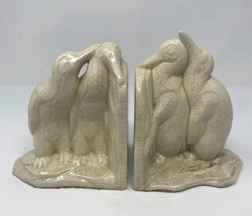 Louis Fontinelle, Crackle Glazed Ceramic Penguins: A set of Louis Fontinelle (French, 1886 - 1964) ceramic bookends of penguins, in cream colored crackle glazed and molded earthenware, each depicting a pair of affectionate standing penguins, size (eac