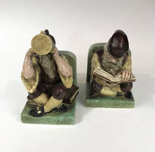 Northwestern Terra Cotta Company Gnome Bookends, c. 1925.: Pair of large and rare, pottery bookends depicting a gnome variously reading, or setting on his book and imbibing from a 3-handled ale mug, slip cast, 6 glaze colors in each piece, size approximately