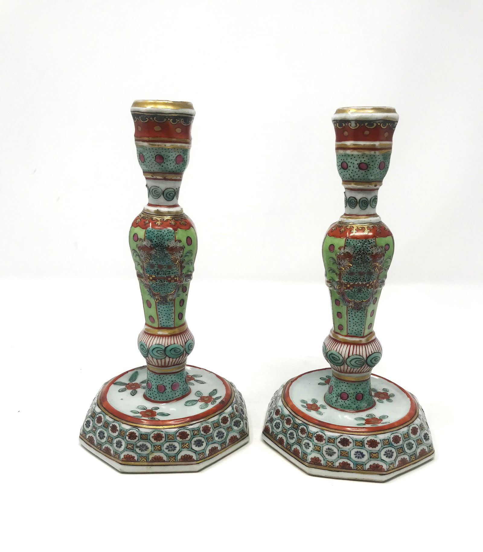 Pair of Antique Asian Candlesticks.: A pair of antique Asian porcelain candlesticks of octaganal design, size: 7 3/4 in. height x 4 1/8 in. width at base, marked on bottom, old Morton's Auction label on bottom, very good condition.