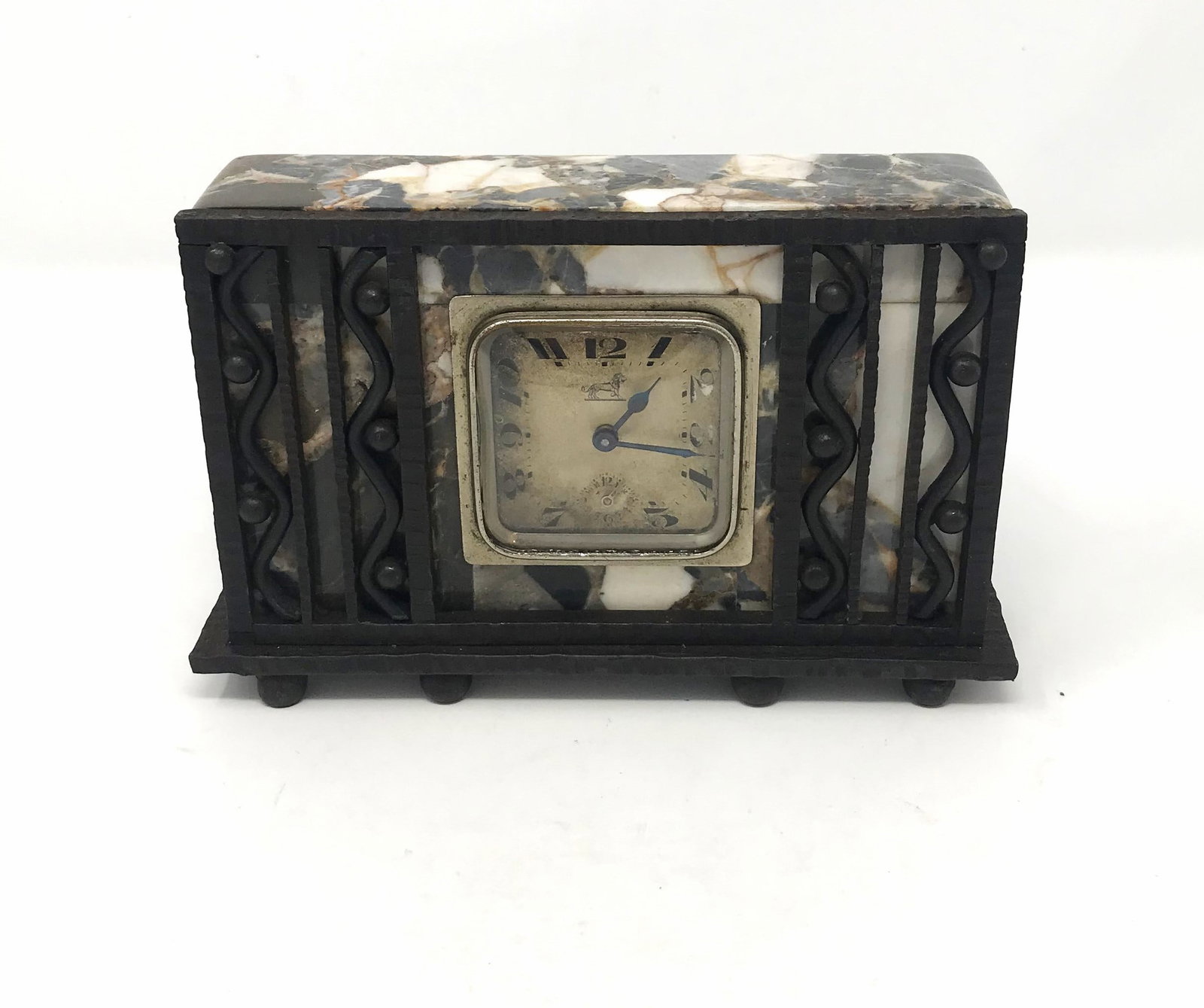Edgar Brandt, Mantle Clock, c. 1925.: Edgar Brandt (FR 1880-1960) Mantle Clock, circa 1925, size: 4 1/2 in. H. x 7 in. W. x 2 in. D., wrought iron pierced front case with iron plinth and iron ball feet, dark patina, brecciated black, whit