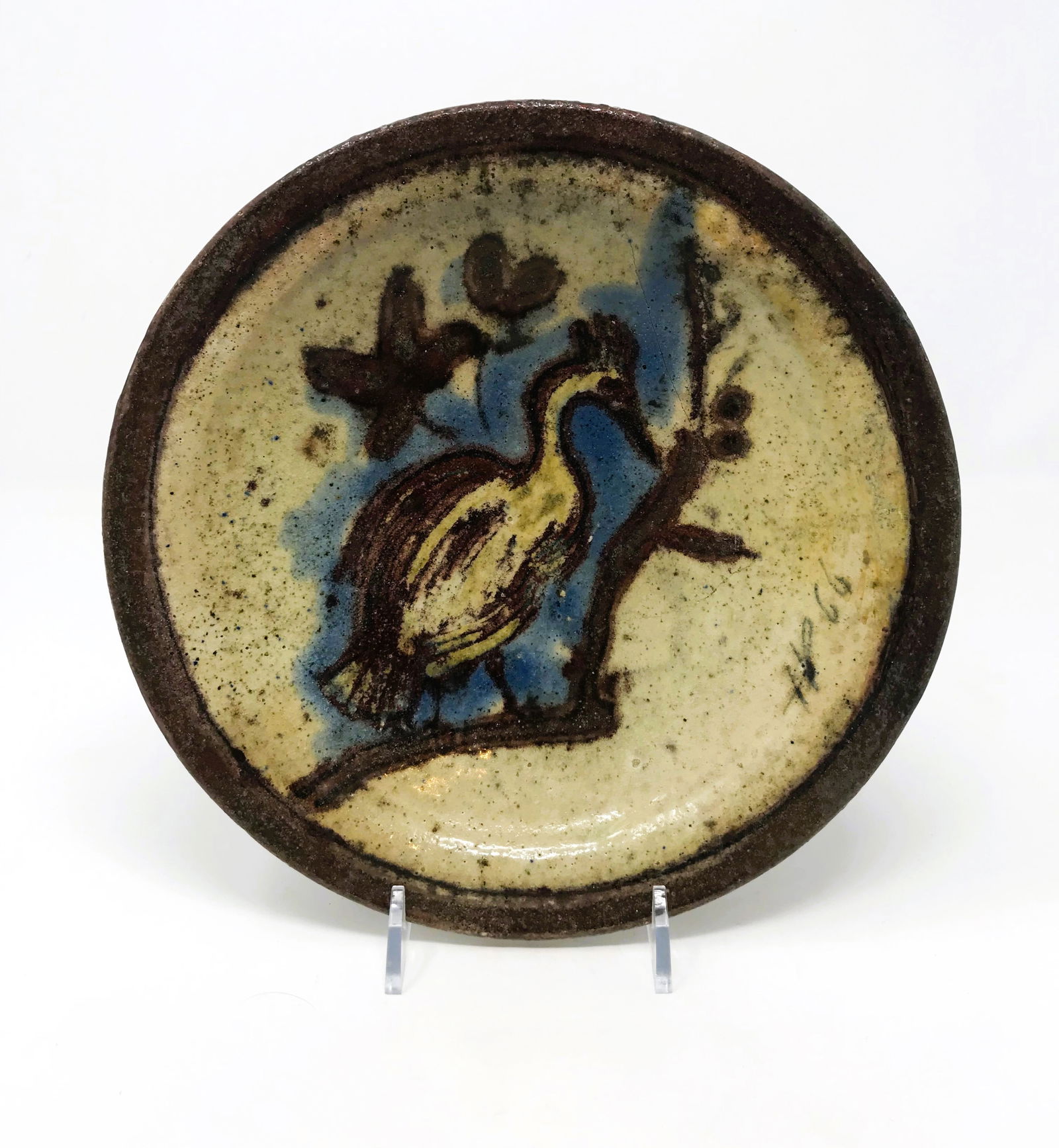 Henry Varnum Poor (1887-1970) Glazed Ceramic Plate: Henry Varnum Poor glazed ceramic plate with Heron and pond scene, 1966, 8 1/8 in. diameter, signed HP 66 on front, incised HVP 65 on base. Small professional repair to crack near edge above signature.