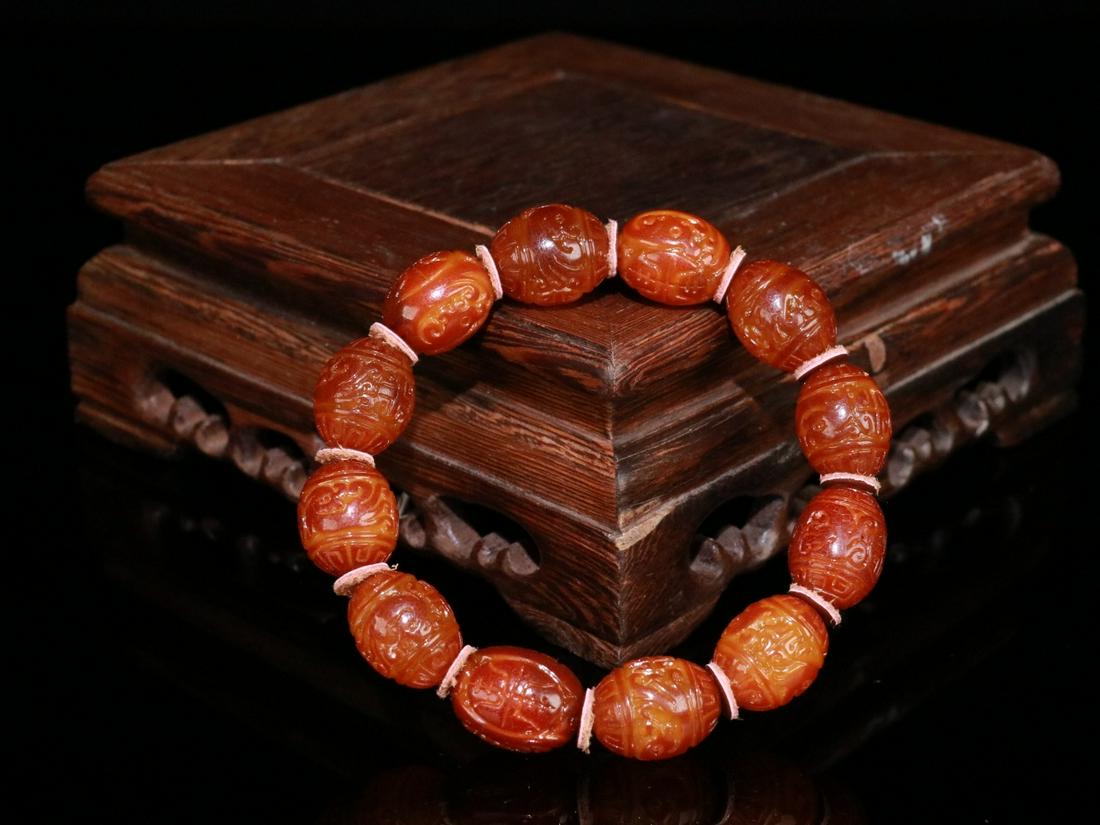 An Amber Dragon Carved Bracelet: Bead-Diameter: 1.8cm; Weight: 25.7g