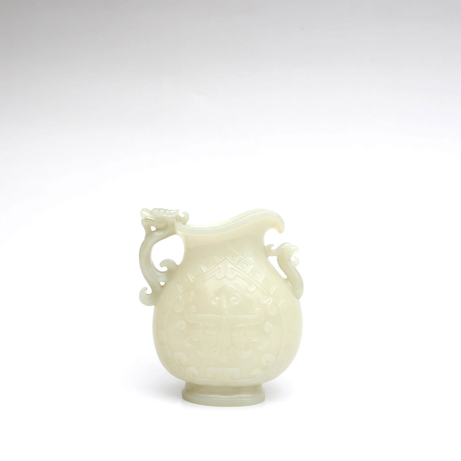 A Dragon&Phoenix Pattern Carved White Hetian Jade: A Dragon&Phoenix Pattern Carved White Hetian Jade Drinking VesselWidth:10cm, Height:14cm,