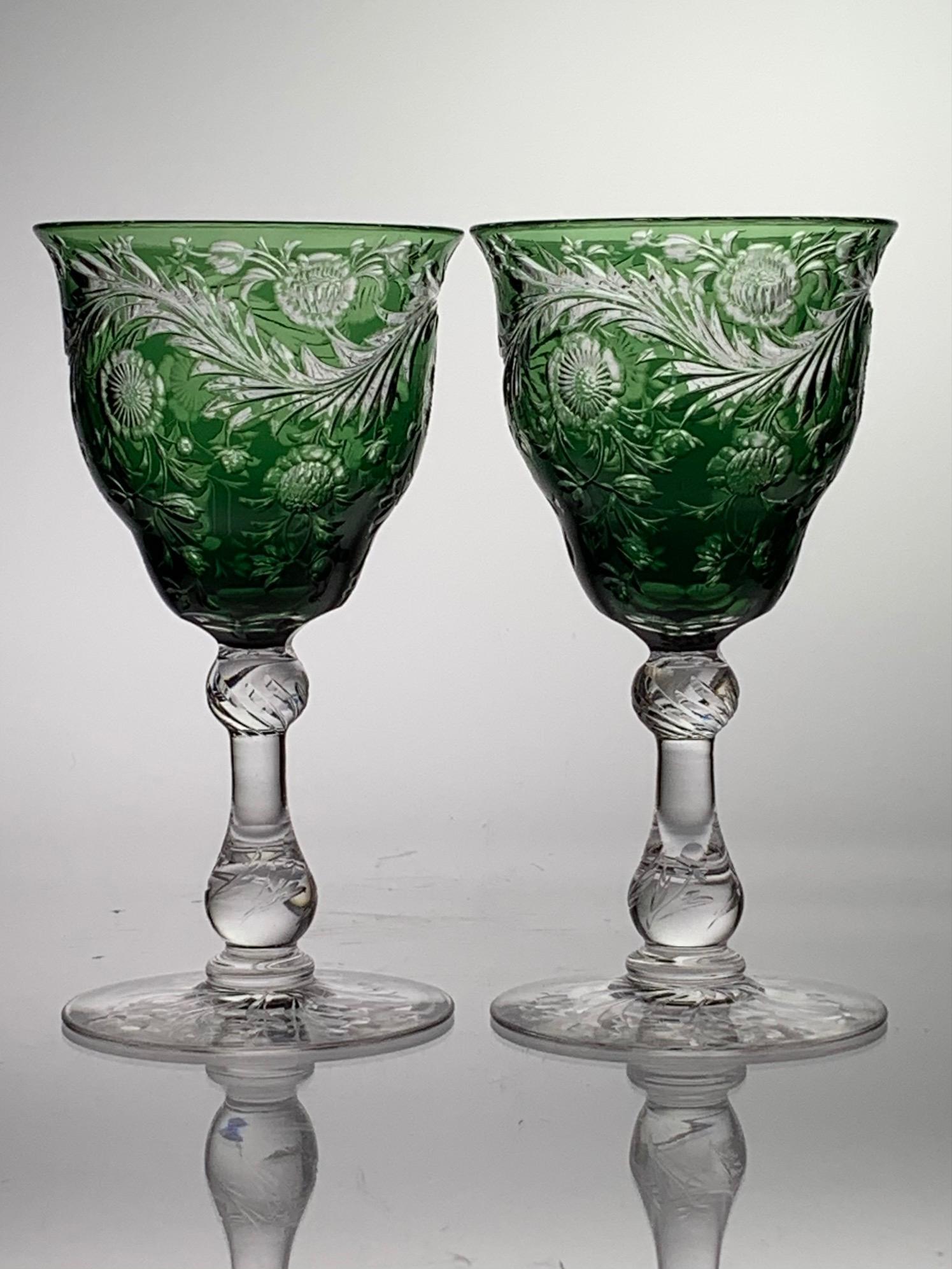 Pair Of Webb English Cut Glass Wines Emerald To Clear: This pair of cut glass wine stems are signed by Webb. Thomas Webb & Sons was an English glass company founded in 1837, Stourbridge, England. They have a deep emerald color cut to clear with a floral d