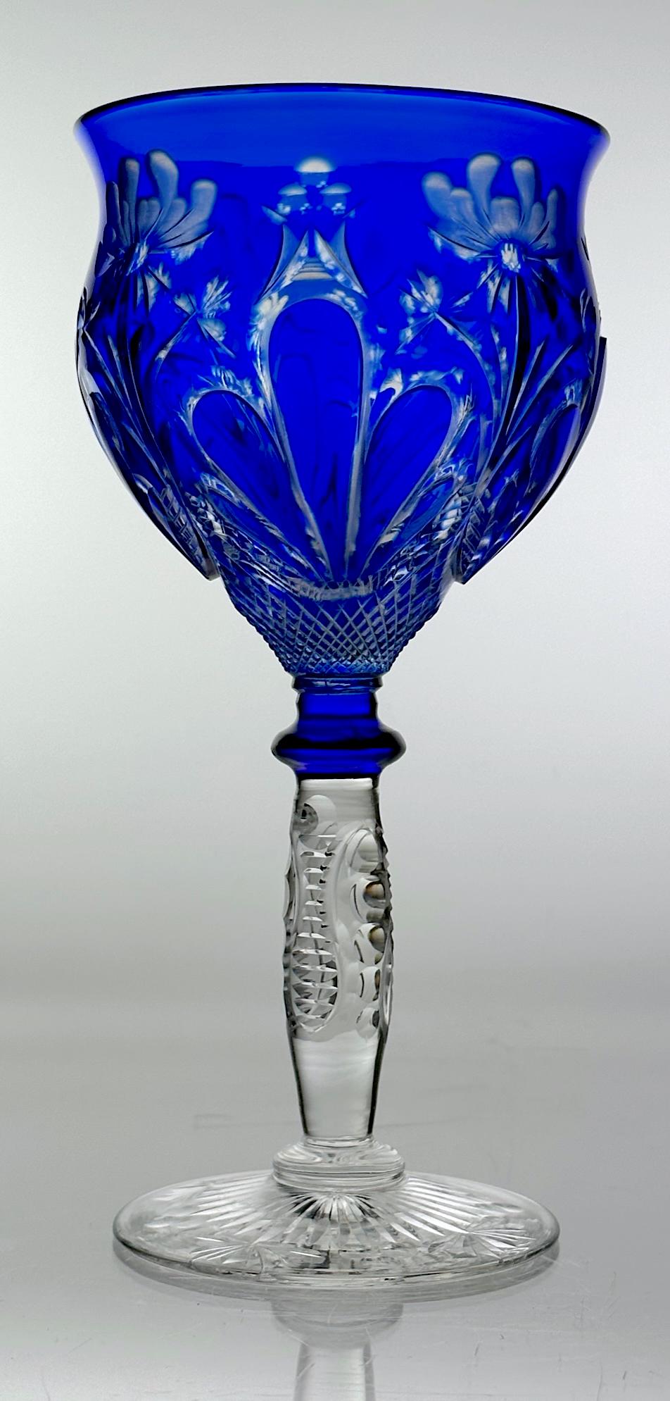Stevens & Williams Cut Glass Wine Stem Cobalt Cut To Clear: Beautiful cut glass white wine stem by Stevens & Williams. Has a nice cobalt blue color cut to clear with a finger and floral design. There is cutting on the stem and foot also. Circa 1900 Dimensions: