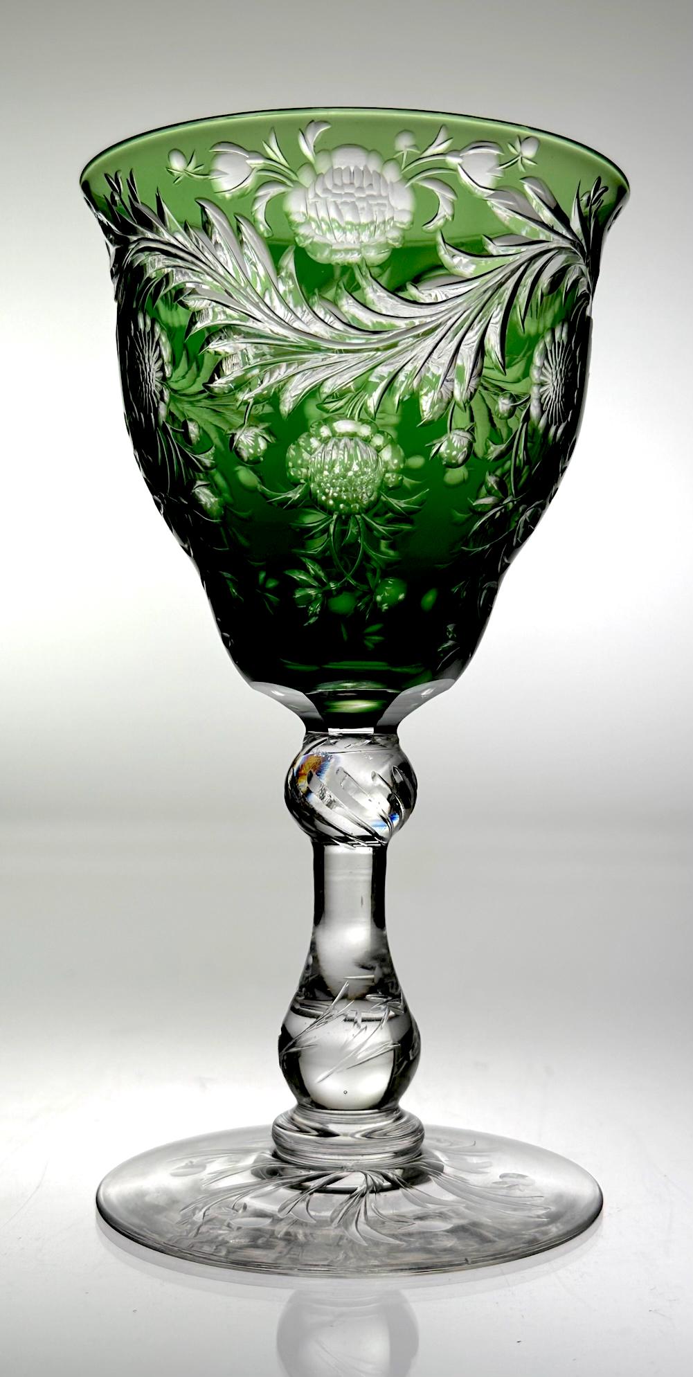 Signed Webb English Cut Glass Wine Stem Green To Clear: Cut glass wine stem signed by Webb. Thomas Webb & Sons was an English glass company founded in 1837, Stourbridge, England. This wine has a deep emerald color cut to clear with a floral design. The sty