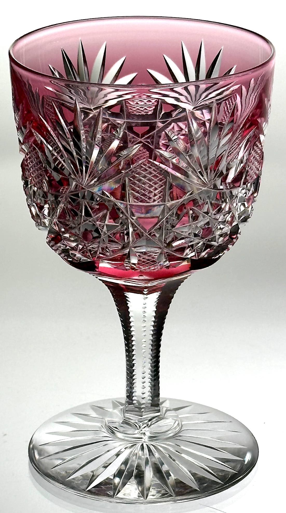 Dorflinger No. 50 Cut Glass Wine Stem Cranberry-Clear: American Brilliant cut glass wine stem in a lovely red color cut to clear. This piece is cut by Dorflinger in their No. 50 pattern. This design has hobstars, fans and crosshatching. We have not see th