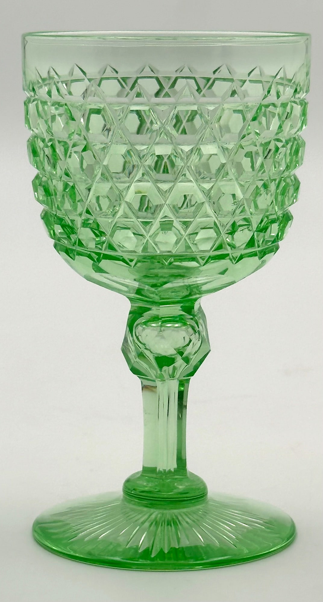 Dorflinger Hob Diamond Cut Glass Wine Stem Solid Vaseline: American Brilliant cut glass wine stem. Cut by Dorflinger in a Hob Diamond pattern. This stem is a solid vaseline color. It has a fluted stem with a faceted knob. The base is cut with a rayed star. Ca
