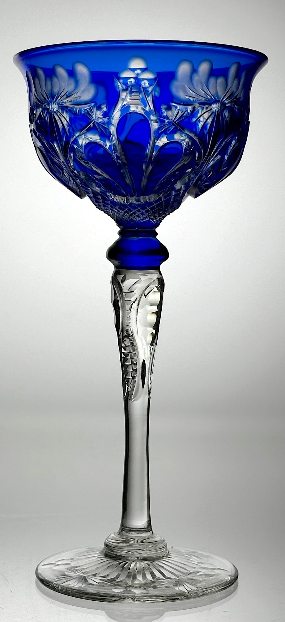 Stevens & Williams Cut Glass Champagne Stem Cobalt: An elegant cut glass champagne stem by Stevens & Williams. It has a beautiful cobalt blue color cut to clear with the floral and finger tusk motif. The stem and the foot are also cut with a floral mot
