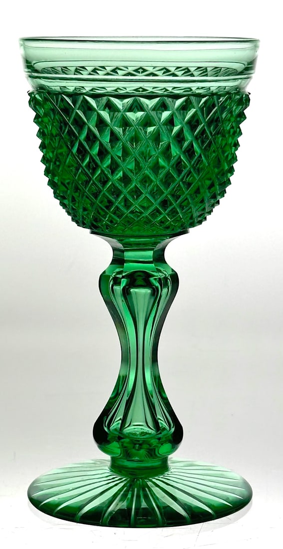 American Brilliant Cut Glass Solid Green Wine Stem: Unique American Brilliant cut glass wine stem. This piece has a solid emerald green color. The bowl is cut with a sharp diamond and it has an apple core stem. The base has a rayed star. This wine will