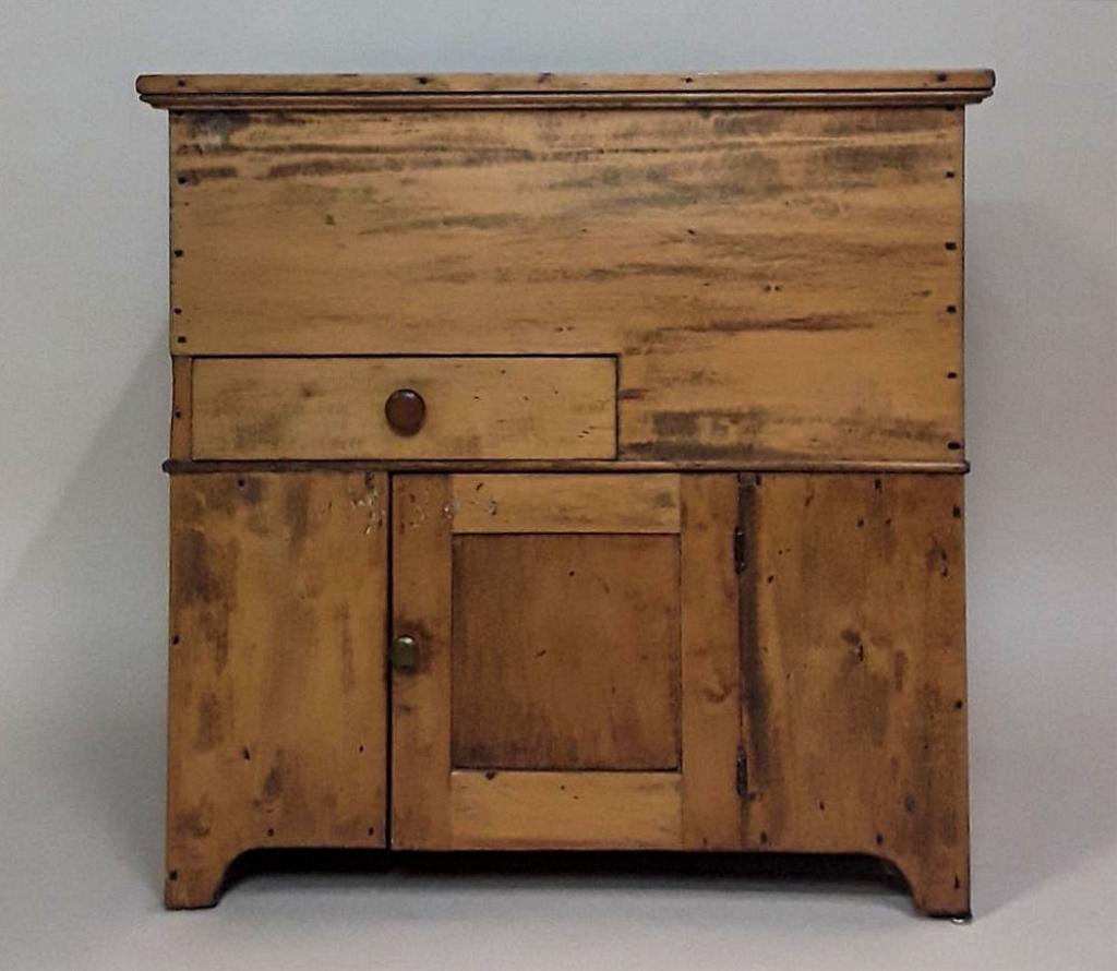 ANTIQUE QUEBEC PINE DRY SINK: Quebec, early to mid19th century Top opens to reveal a stepped dry sink, with a single drawer and a lower cabinet 29" h x 30" w x 17" d