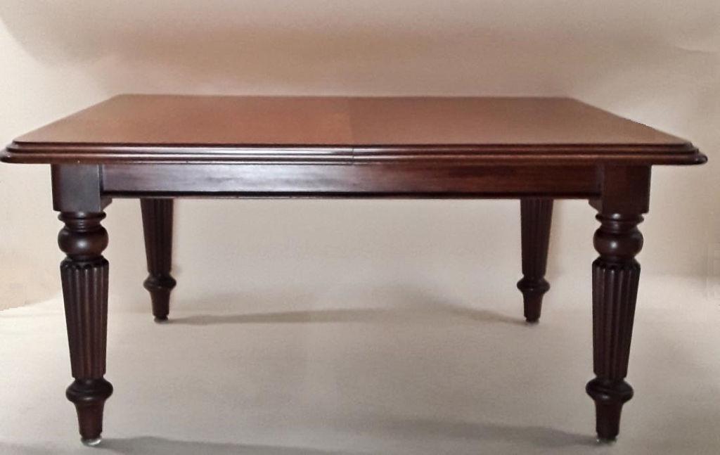 IMPRESSIVE VICTORIAN DINING TABLE: English, late 19th century Mahogany with substantial reeded legs and two leaves Seats twelve when fully extended. Crank included. 30" h x 61" x 48" and leaves together 37" x 48". Provenance: Property 