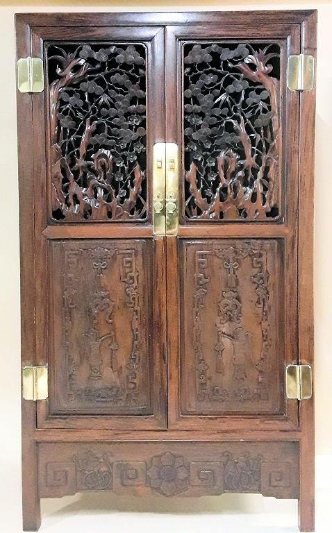 VINTAGE ASIAN CUPBOARD: Probably Chinese, circa mid 20th century, Rosewood with well-carved doors and brass mounts Shelves in interior. 69"h x 39"w x 15.5"d. Provenance: Property of the late Senator Cairine Wilson, 1885 - 19