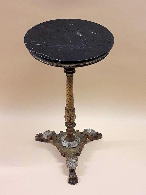 ANTIQUE MARBLE-TOPPED GUERIDON: French, 19th century Black marble top on a cast single pedestal metal base with a cross-hatch pattern and leaf deign on the column supported on three splayed paw feet.. 30" h x 16"d