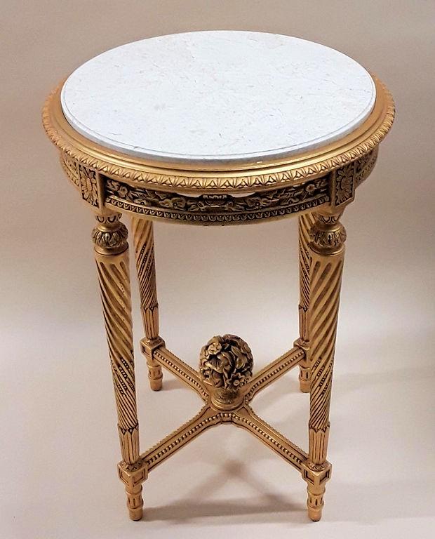VINTAGE MARBLE TOP GILTWOOD GUERIDON: European, late 20th century Carved gilt frame with a floral design to the apron, spiral carving to legs and a beaded X cross stretcher wiith a floral bouquet finial. 31" high x 21.25" diameter
