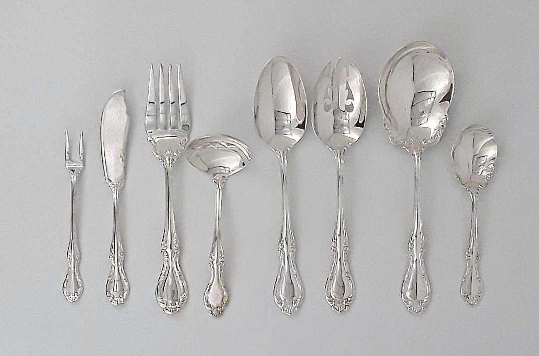 NORTHUMBRIA STERLING SERVING PIECES: Northumbria sterling silver, "Cello" pattern Eight piece lot consisitng of: a master butter knife; two table spoons; a large serving spoon; a meat fork; a sugar spoon; a pickle fork; and a ladle. 458 