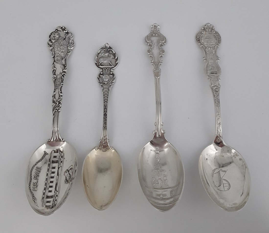 FOUR ANTIQUE DECORATIVE STERLING TEASPOONS: Various makers and dates. Fancy details on each spoon, including: a US Mail rail car in the bowl and a dog figure in the handle; Aries and a ram above a cupid's head on the handle; a classical scene w