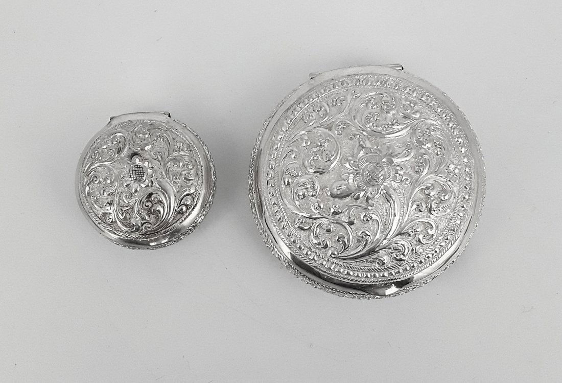 VINTAGE SILVER PILL BOXES: Two nice unmarked silver; hinged boxes having floral and foliate repousse details to lids. 0.5" x 1.5" and 0.75" x 2" and 50 grams