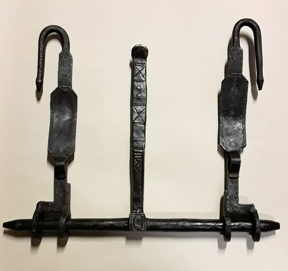 ANTIQUE WROUGHT IRON CASTLE GATE LATCH: Spanish. Rare antique hand-made cast iron gate latch, with decorative etching and curved ends fashioned in the form of serpents, with a slide bolt design. 20” x 25.5"