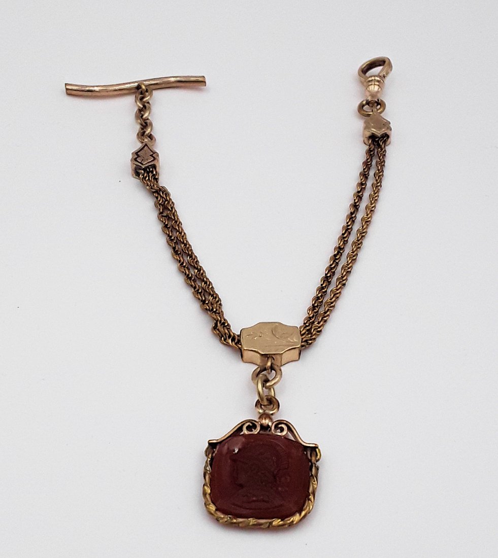 EDWARDIAN SLIDER WATCH CHAIN AND FOB: Early 20th century/late 19th century Gold filled rope style chain with a slider length adjuster and a nice intaglio engraving of a helmeted ancient Greek head in profile. 9.5" short length