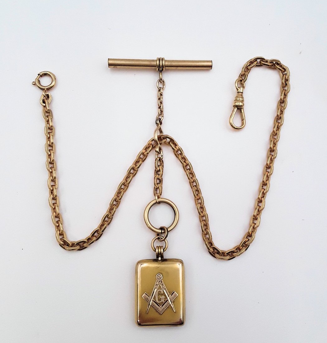 ANTIQUE POCKET WATCH CHAIN WITH MASONIC LOCKET: Late 19th / early 20th century Cable link watch chain and a gold filled locket with a Freemason symbol on one side. 13" long