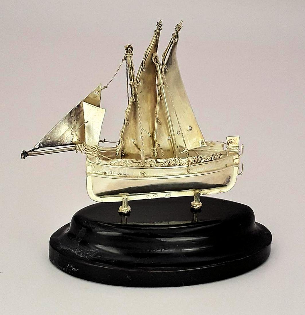 MINIATURE STERLING SILVER SAILING SHIP: Maltese, last quarter 20th century Scale model in sterling silver of a craft in full sail 3" h excluding stand x 3.75" w x 1" d