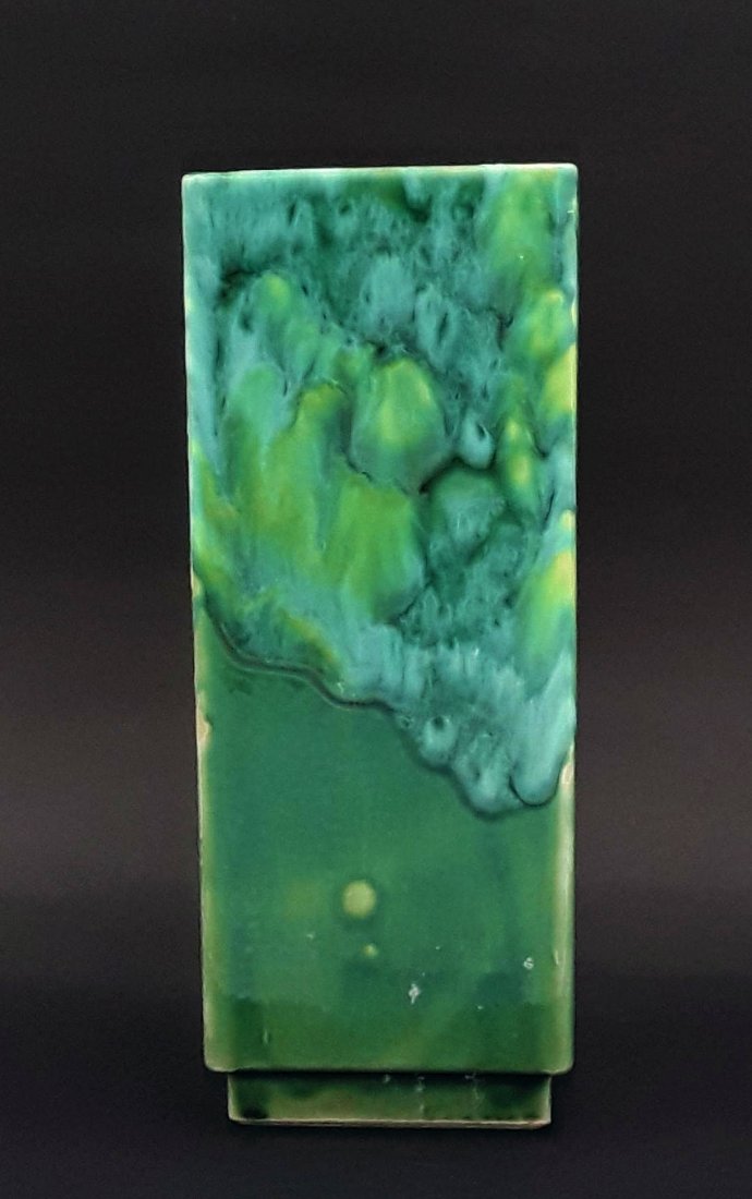 MID CENTURY BEAUCE ART POTTERY VASE: Quebec, Canada circa late 1940s/1950s Tall square vase with an interesting polychrome platter pattern on a green ground above a stepped foot. 9.5" h x 4" x 4"
