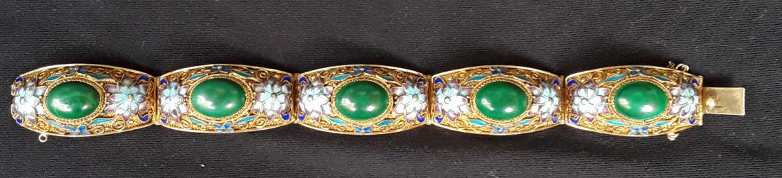 CHINESE VERMEIL AND MALACHITE BRACELET: Well made silver gilt bracelet stamped "silver" on the clasp. The bracelet is in five sections each with a cabochon set malachite stone and having pretty blue enamel flowers and filigree work.Good con