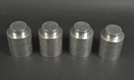 19TH CENTURY CHINESE TEA CANISTERS: China, circa 1840 A set of four silvered tea canisters having finely etched flowers in cartouches on the sides and on the lids along with a scrolling design along the edges. 3.75" x 2.75"