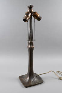 ART NOUVEAU HANDEL LAMP BASE: United States, circa 1900. Handel Lamp Company, Connecticut. Cast metal/bronze lamp base with flowing lines along the sides to the base. 21" x 6.25"